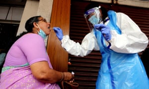 An Indian Health worker carries out a Covid test in Bangalore.