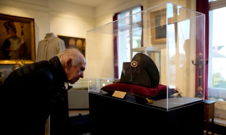 A visitor views one of the signature broad, black hats that Napoleon wore when he ruled 19th-century France.