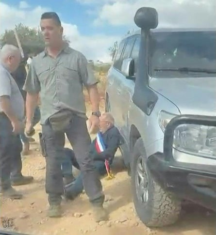 Screen grab of an Israeli settler attack on European officials, including a French mayor pictured leaning against car in his red, white and blue sash.