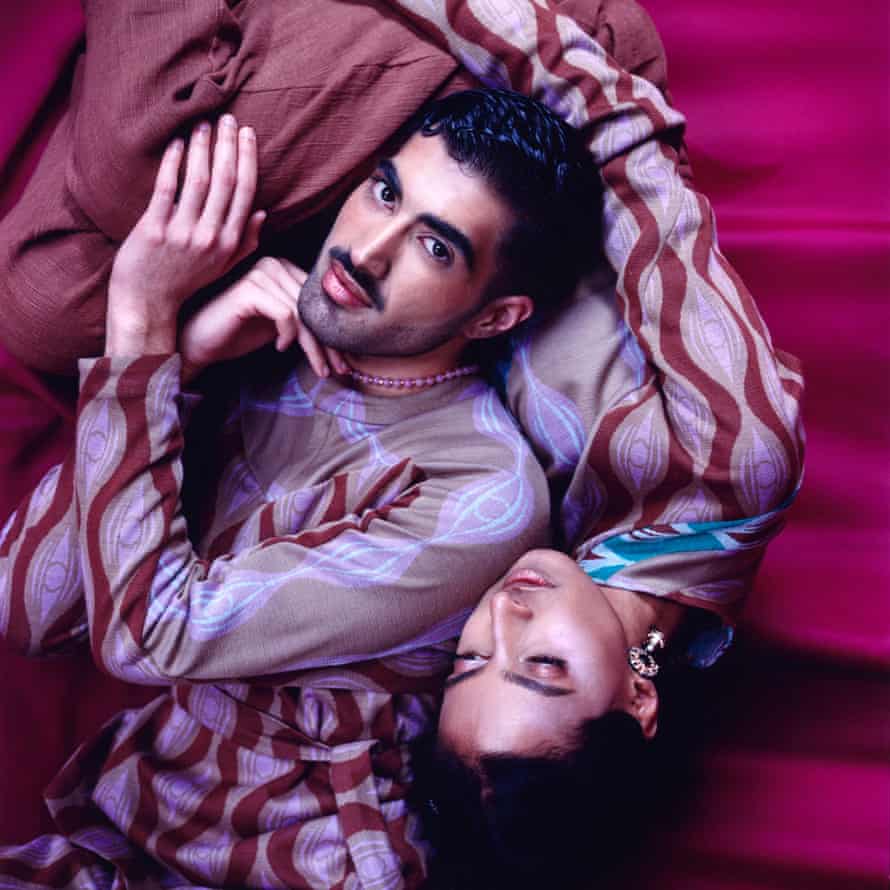 Two figures, intertwined, in purple dyed tops