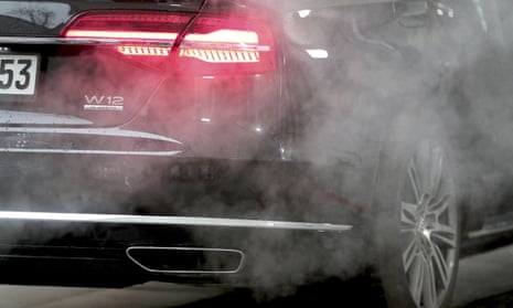 A luxury Audi car is surrounded by exhaust gases