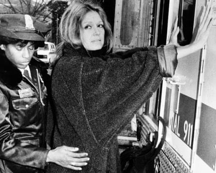 A police officer arrests Steinem during an anti-apartheid protest outside the South African embassy in Washington DC, December 1984.