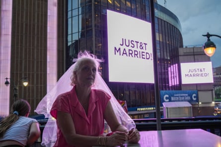A Taylor Swift fan wearing a wedding veil next to Madison Square Garden.