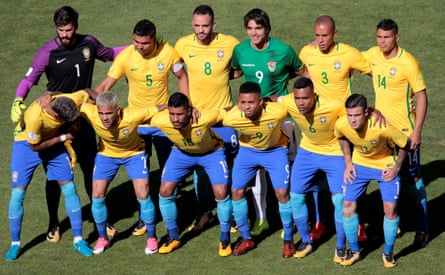 Bolivia’s Marcelo Martins (in green) lines up with the Brazil team.