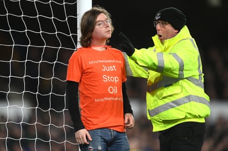 A protester ties himself to the goalpost during the match between Everton and Newcastle at Goodison Park