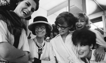Coco Chanel surrounded by models at the Chanel studio