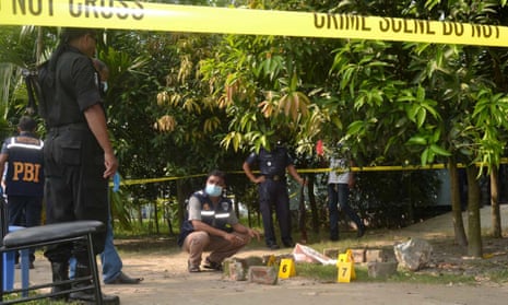 Bangladeshi security officers examine the site where Kunio Hoshi was killed in Rangpur.