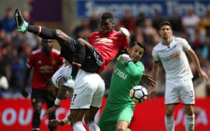 Paul Pogba balances on top of Kyle Bartley as Lukasz Fabianski tries attempts to clear as Manchester United score four past Swansea City at the Liberty Stadium.