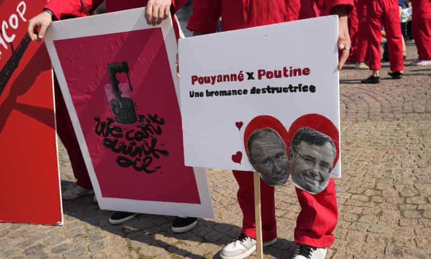A placard at a Paris climate protest showing Vladimir Putin and the TotalEnergies CEO, Patrick Pouyanné