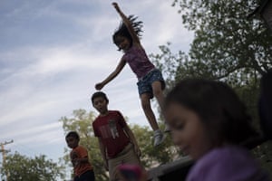 Eight-year-old Jeremiah Lennon, second from left, plays on a trampoline with relatives in Uvalde