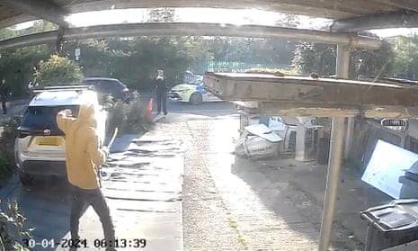 Handout footage from a doorbell camera of police officers tasering a sword-wielding man in Hainault.