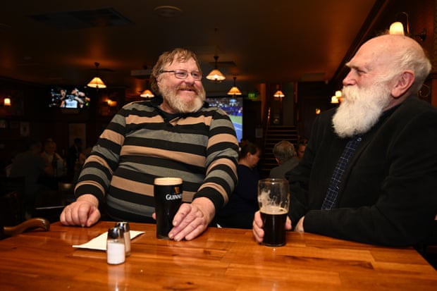 Ray Dit (left) and John Myers remember the Queen over beer at the Charles Dickens Tavern in Melbourne
