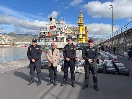 Spanish police stand in front of some of the nearly 10 tonnes of cocaine seized on a cargo ship sailing across the Atlantic between Brazil and Spain