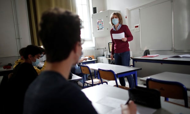 A masked teacher in a classroom in Paris
