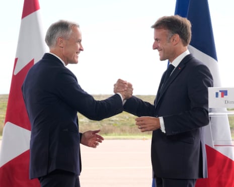 Canada's Mark Carney and France's Emmanuel Macron shake hands in the French territory of Saint-Pierre âÂÂand Miquelon