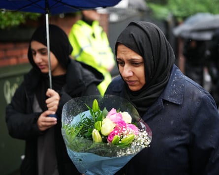 People with flowers before a vigil to be held after the attack at the Heaton Park Hebrew Congregation synagogue, Manchester, 3 October 2025.