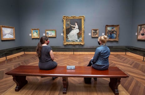 Visitors wearing PPE sit apart as they view Eva Gonzales, 1870, by Edouard Manet, at the National Portrait Gallery, London, as it prepares to reopen following the easing of coronavirus lockdown restrictions across England.