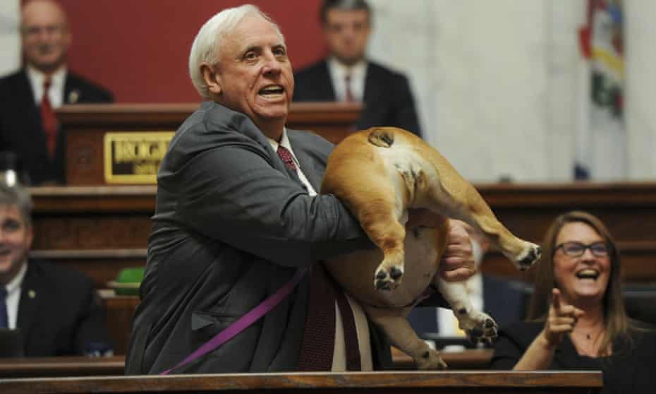 Jim Justice holds up his dog Babydog's rear end as a message to people who've doubted his state.