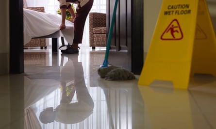 Asian maid cleaning a luxury hotel room