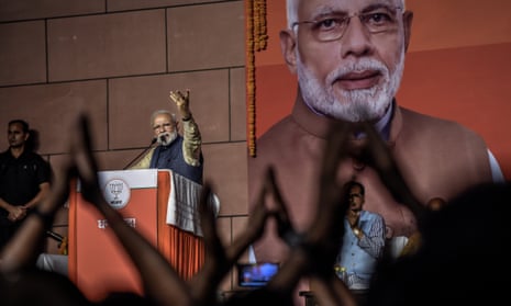 Narendra Modi speaks to party workers at the BJP headquarters after the party’s landslide victory