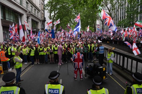 People take part in Tommy Robinson's Unite the Kingdom march in central London.