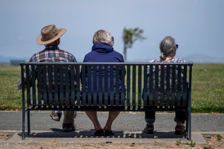 three people sitting on a bench