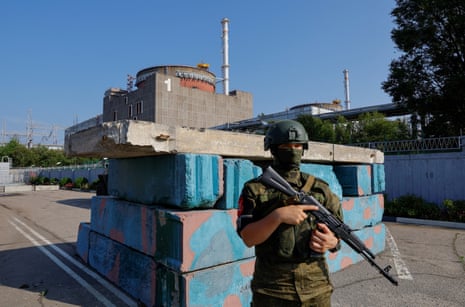 Russian service member stands guard at a checkpoint near the Zaporizhzhia Nuclear Power Plant in June 2023.