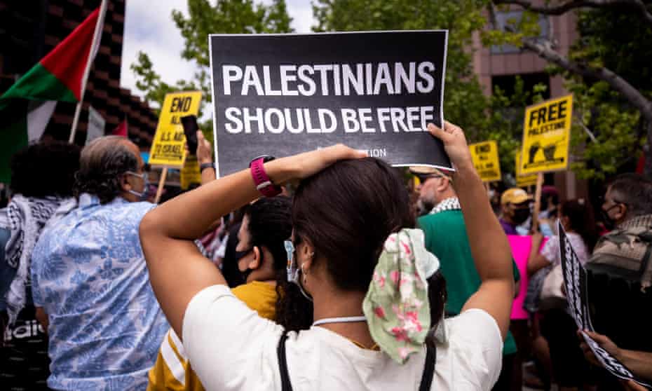 A person holds a poster reading ‘Palestinians should be free’ during a demonstration in front of the consulate general of Israel in Los Angeles, California, on 11 May. 