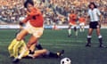 Dutch midfielder Johan Cruyff dribbles past Argentina goalkeeper Daniel Carnevali on his way to scoring in the 1974 World Cup quarter-final in Gelsenkirchen.