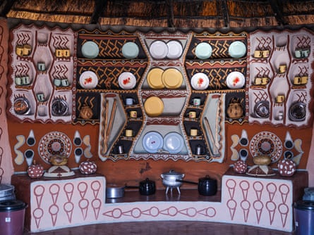 Richly decorated interior – shelving with plates and cooking utensils underneath