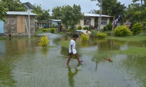 Fijian girl walks over flooded land in Fiji 2467.jpg?width=300&quality=85&auto=forma