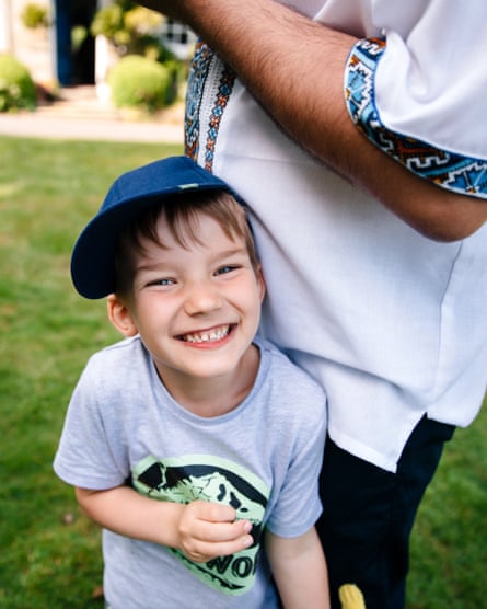 Danyil leans against his father