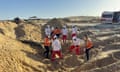Red Crescent workers digging in sand