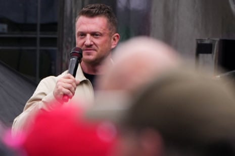 Tommy Robinson talking on microphone at his rally.