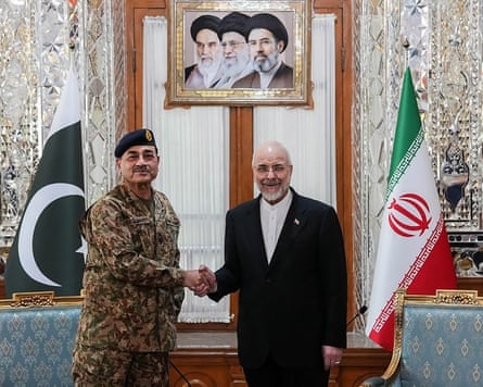 Iranian Parliament speaker Mohammad Bagher Ghalibaf, right, shaking hands with Pakistan’s Army chief Asim Munir before a meeting in Tehran.