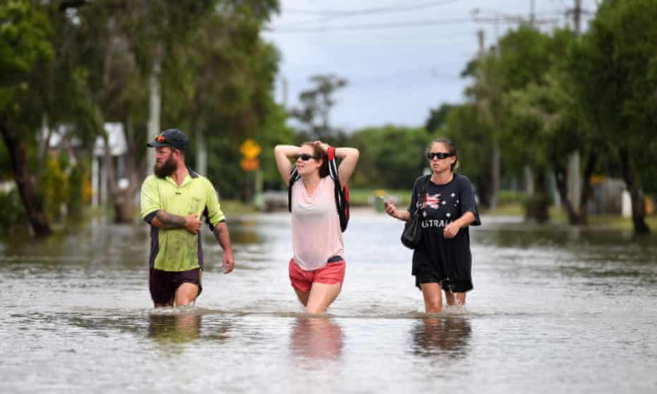 Residents wade through floodwaters