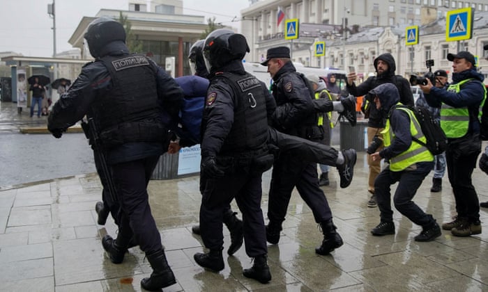 Russian law enforcement officers detain a person during a rally against the mobilisation of reservists ordered by President Vladimir Putin, in Moscow on Saturday