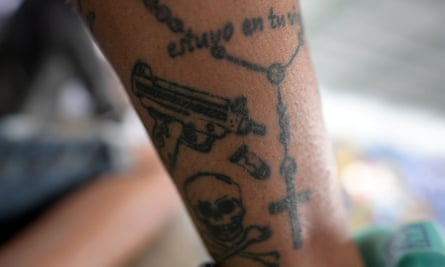 A former combatant of the rightwing paramilitary group United Self-Defence Forces of Colombia (AUC) shows his tattoos during the first National Meeting of AUC ex-combatants in Puerto Boyacá, on 6 May.