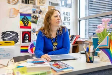 a teacher sits at a desk