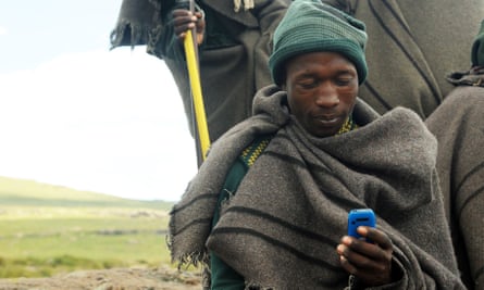 A Lesothan shepherd uses a mobile phone in Northern Drakensberg.
