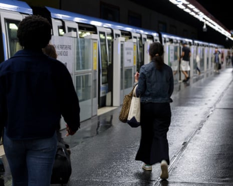 People getting on the train in the Paris underground