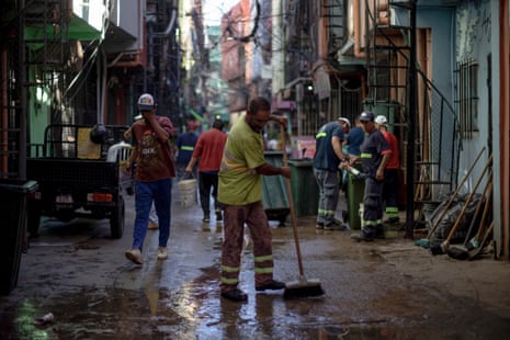 Street cleaners at work in the narrow streets of Villa 31, a slum in Buenos Aires, Argentina.