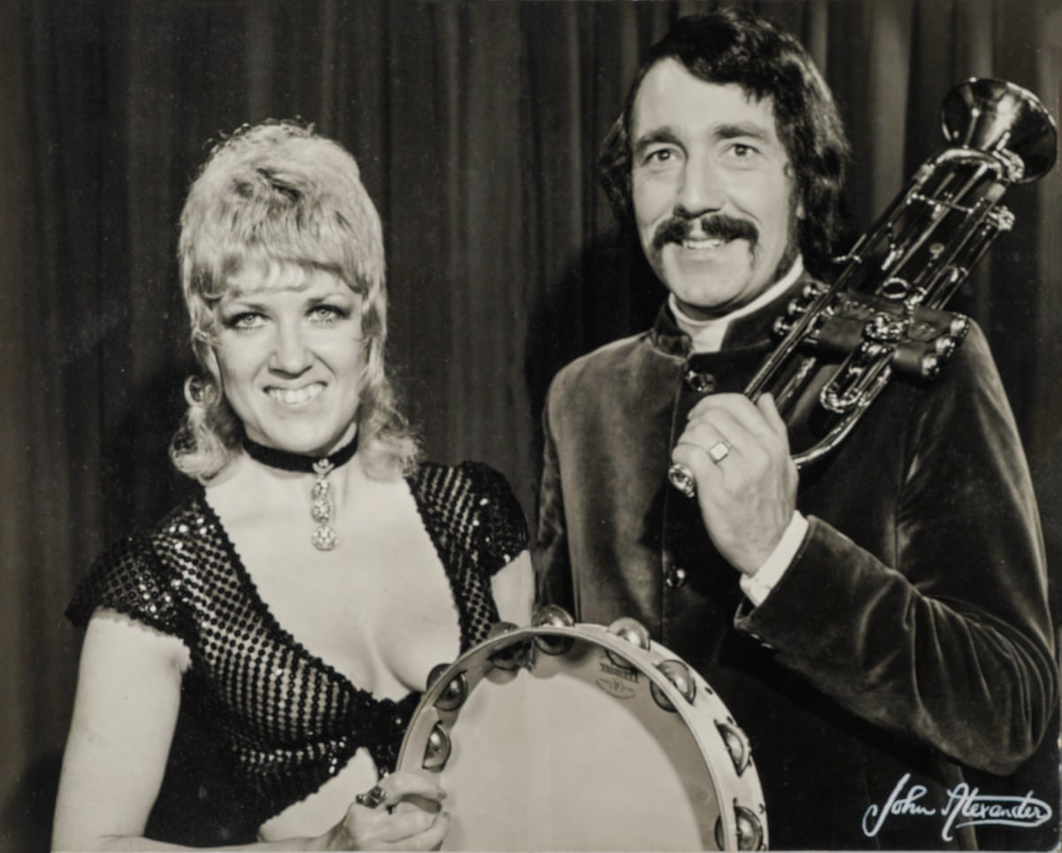 Beryl Plummer with her husband Tommy Wallis. She is holding a tambourine and he is holding a trumpet