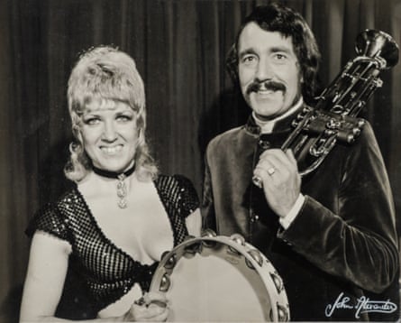 Beryl Plummer with her husband Tommy Wallis. She is holding a tambourine and he is holding a trumpet