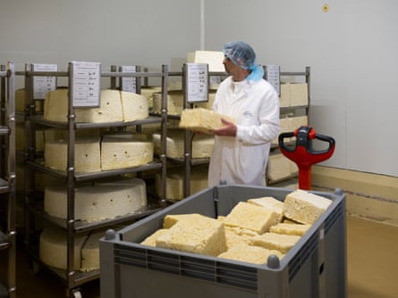 Nicolas Maire, a cheesemaker, stands in a room where metton is stored