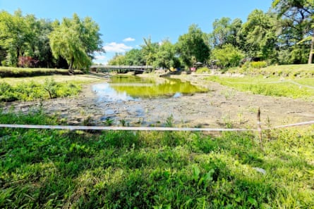 A bridge over a dried up body of water in a park