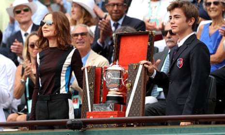 The ladies singles trophy is shown to the crowed inside Court Suzanne Lenglen prior to the ladies singles final .