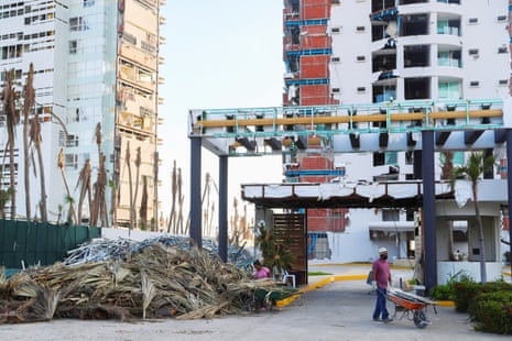 essay about mexico city A man pushes a wheelbarrow near a pile of debris at Punta Diamante, a month after Hurricane Otis hit Acapulco, on 25 November.