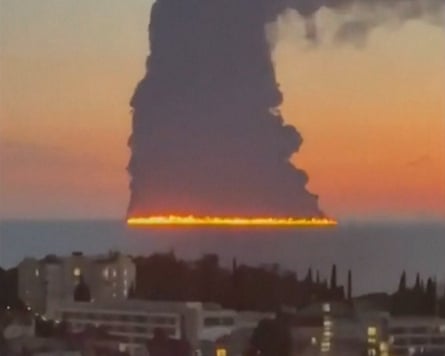 Smoke rising from a large fire on the horizon
