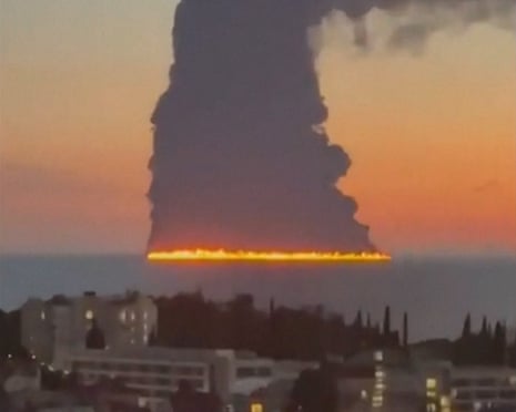 Video released on social media shows smoke rising from a tanker that caught fire after coming under attack in the Black Sea off Sochi, in Russia.